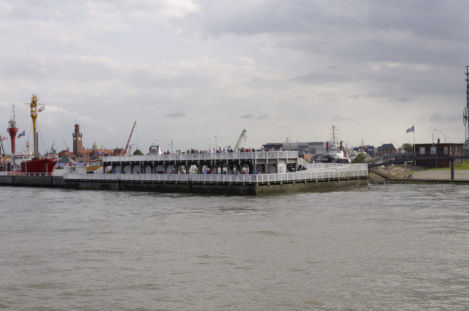 The historic Alte Liebe observation platform in Cuxhaven with visitors watching ships pass on the Elbe