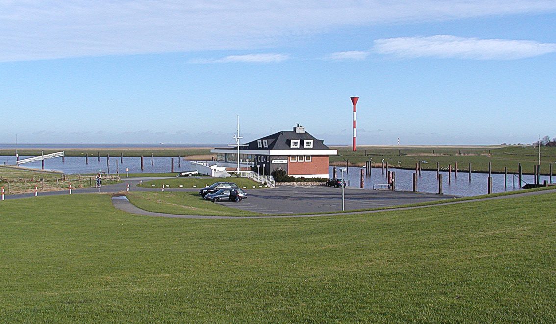 Otterndorf marina with harbour building, boats and a view over the Elbe estuary